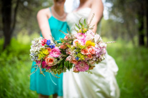 bride and bridesmaid holding flowers