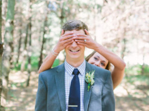 Bride covering groom's eyes for first look