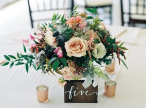 wedding planner completes floral arrangement