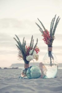 florals in vase on beach